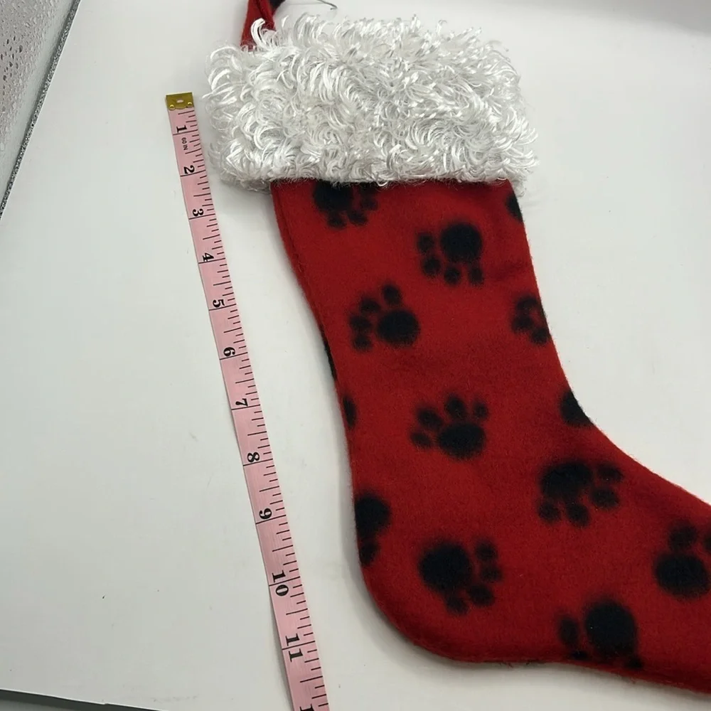 Red Christmas Stocking with Black Paw Prints.